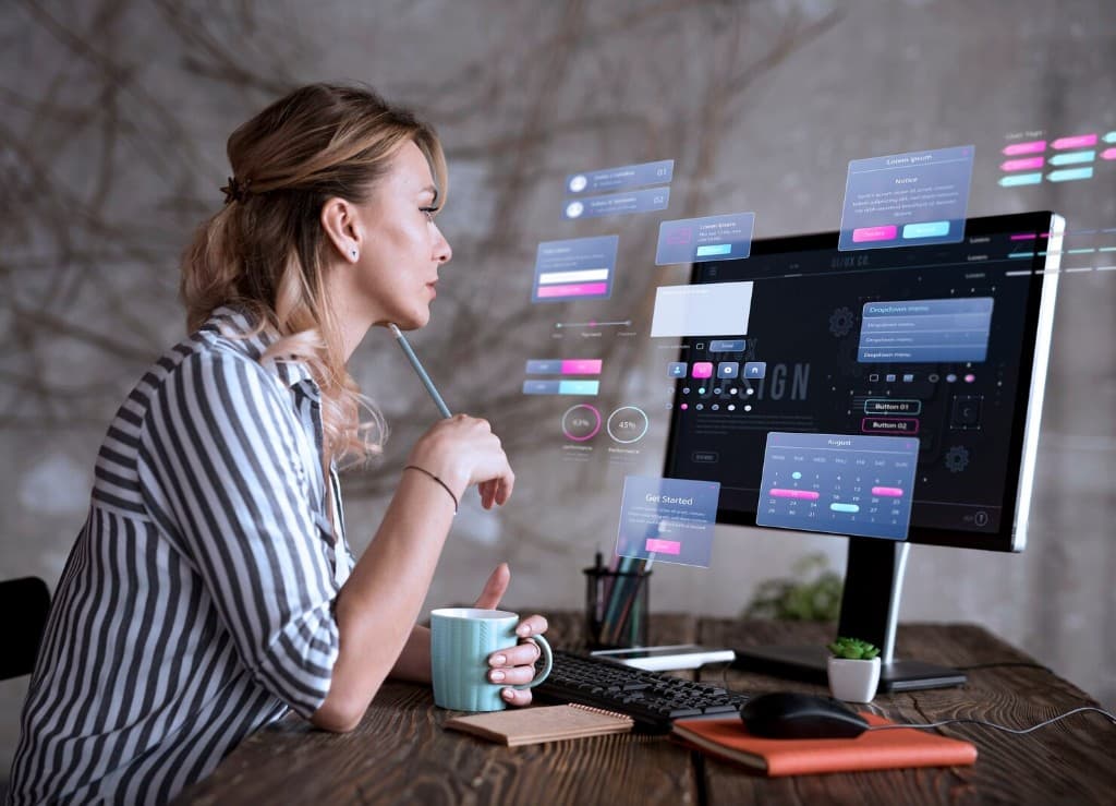 Designer reviewing holographic UI components at a workstation